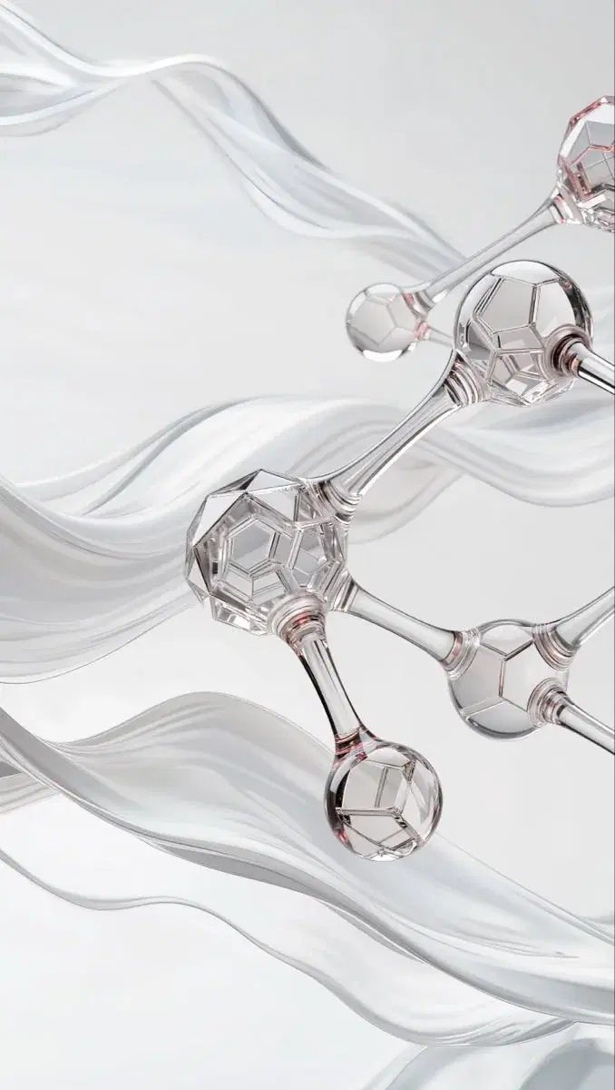A glass model of a molecule against draped white fabric.