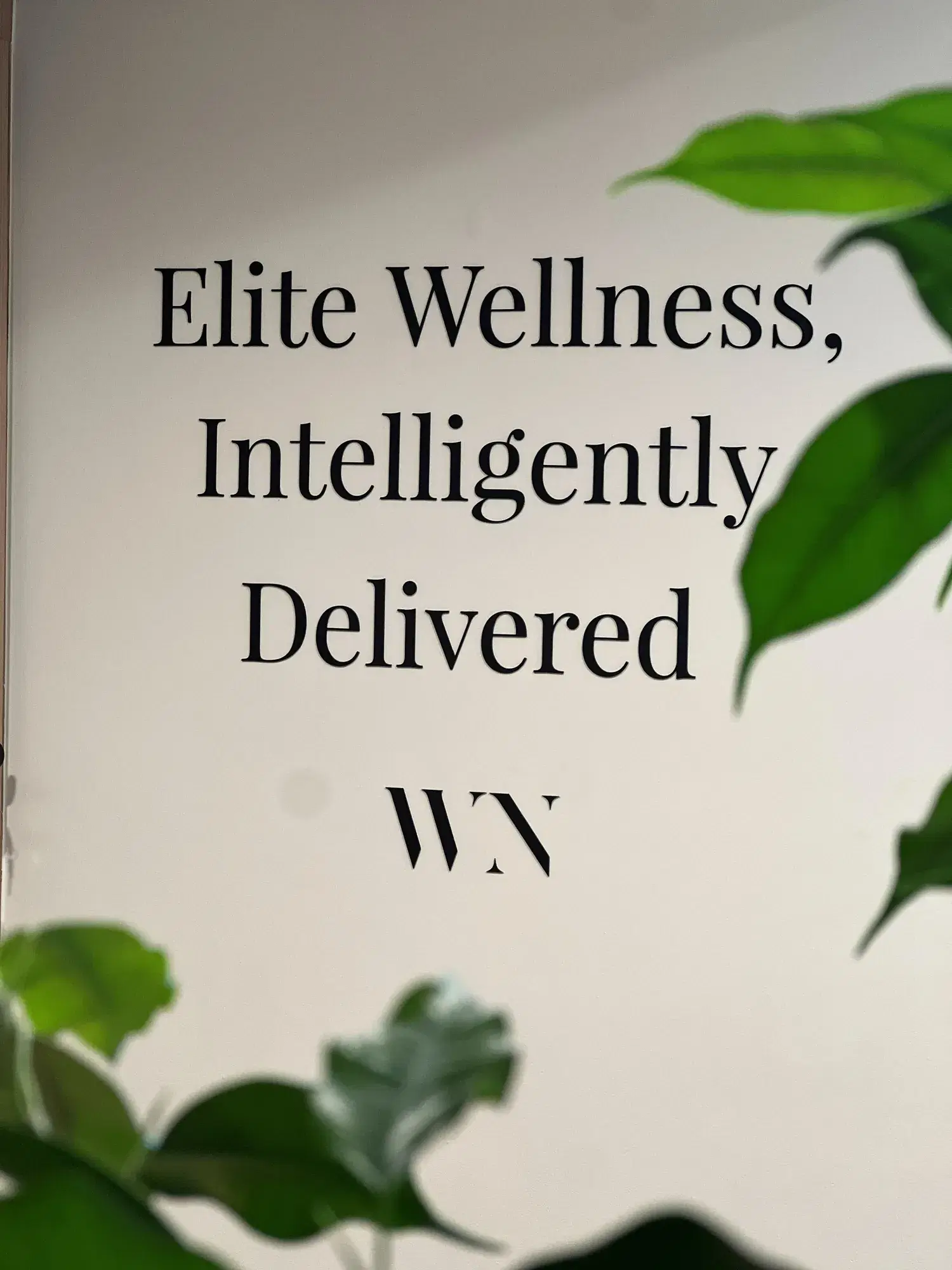 Clinic wall signage reading Elite Wellness, Intelligently Delivered.