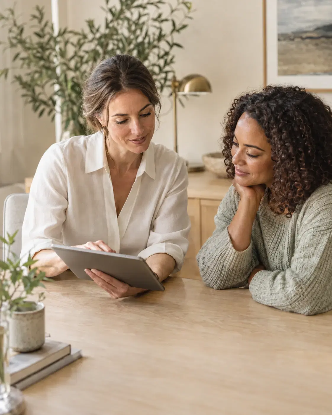 Illustrative clinician and patient reviewing a tablet together