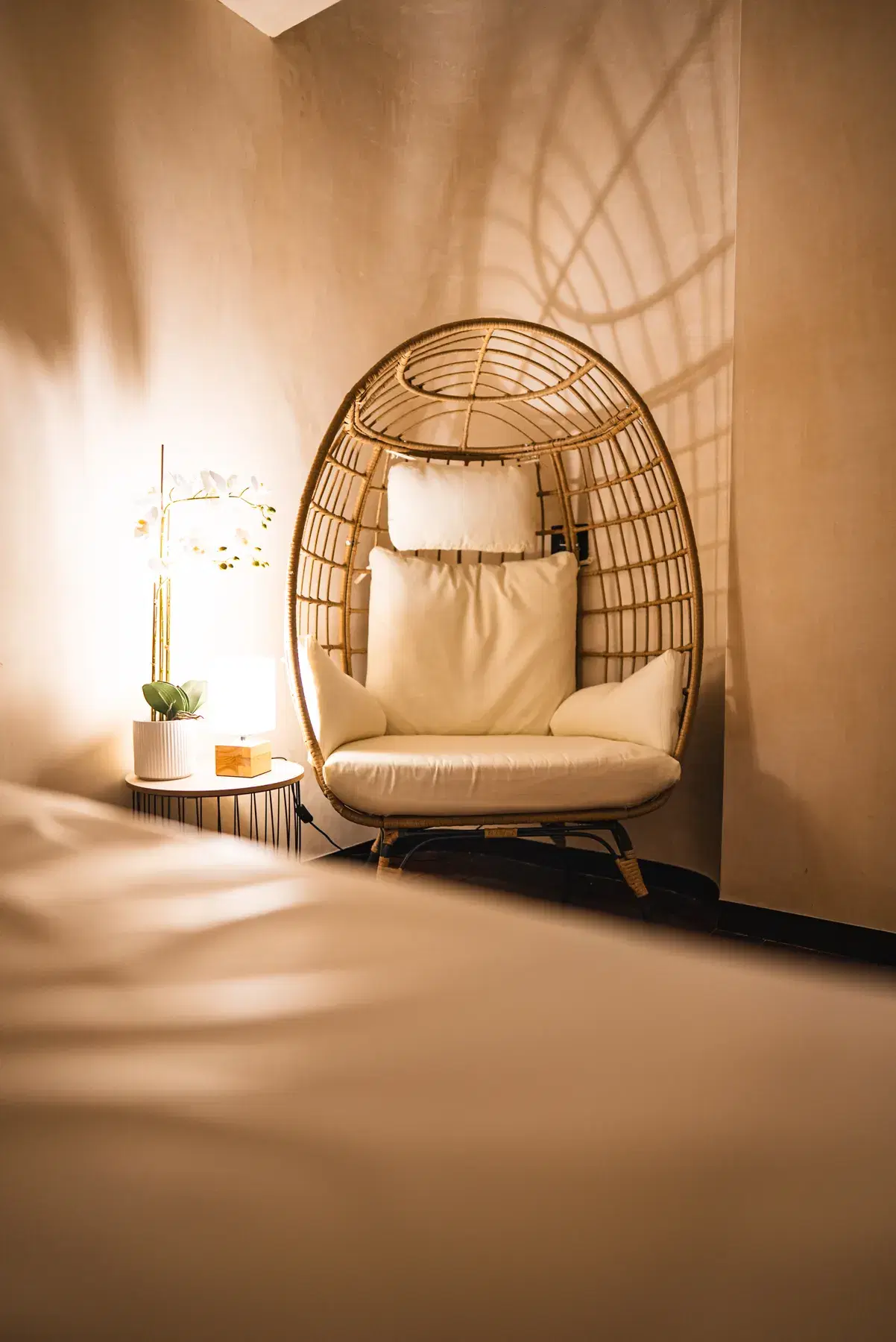 A hanging rattan chair in a quiet corner at WellNest
