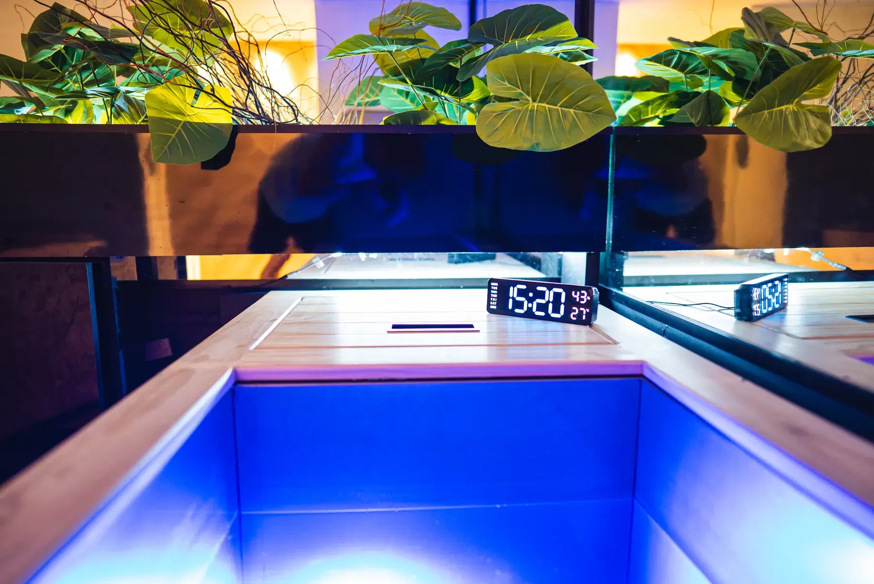 A cold plunge bath lit blue in the WellNest contrast therapy room