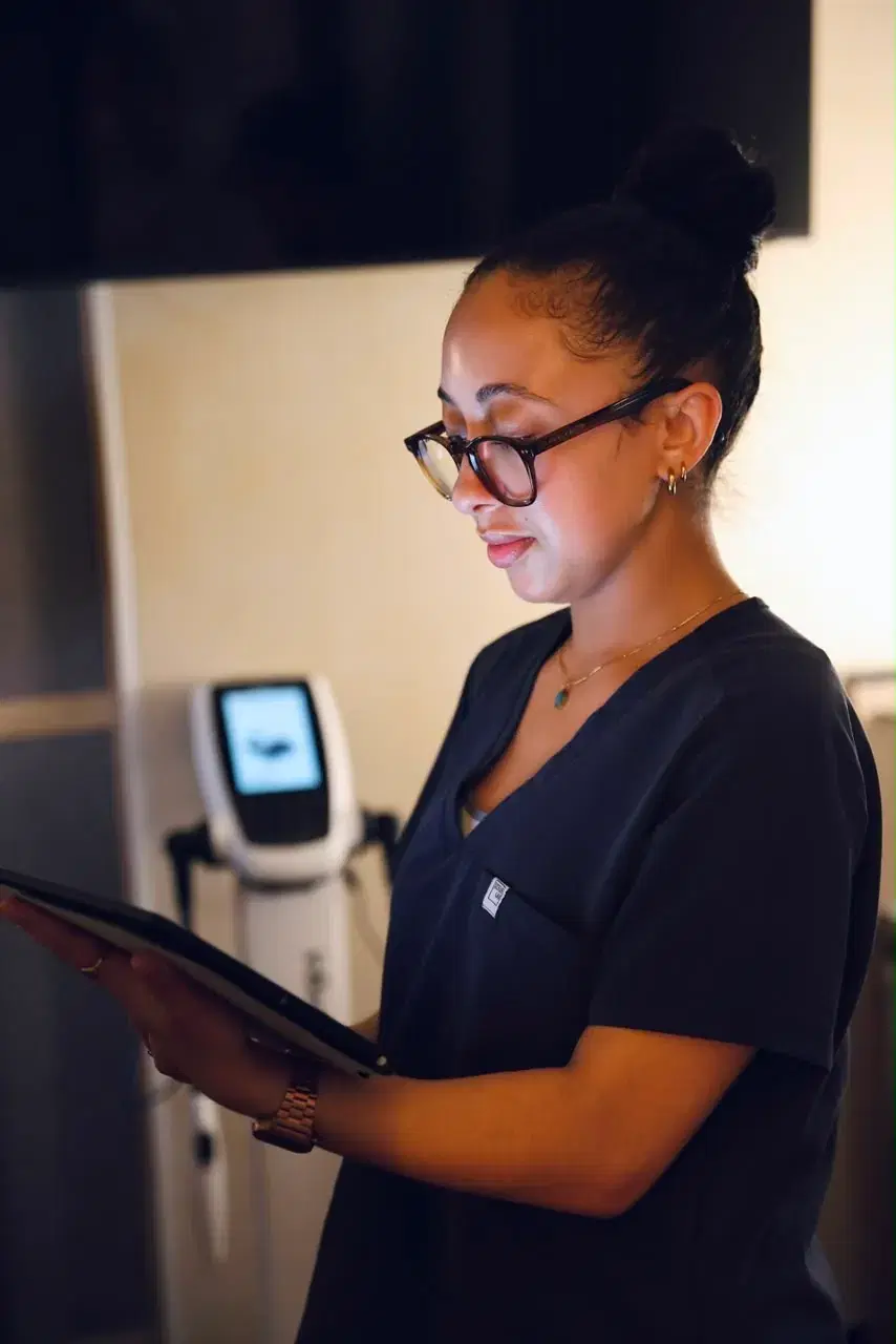 Team member reviewing a tablet beside the InBody analyser